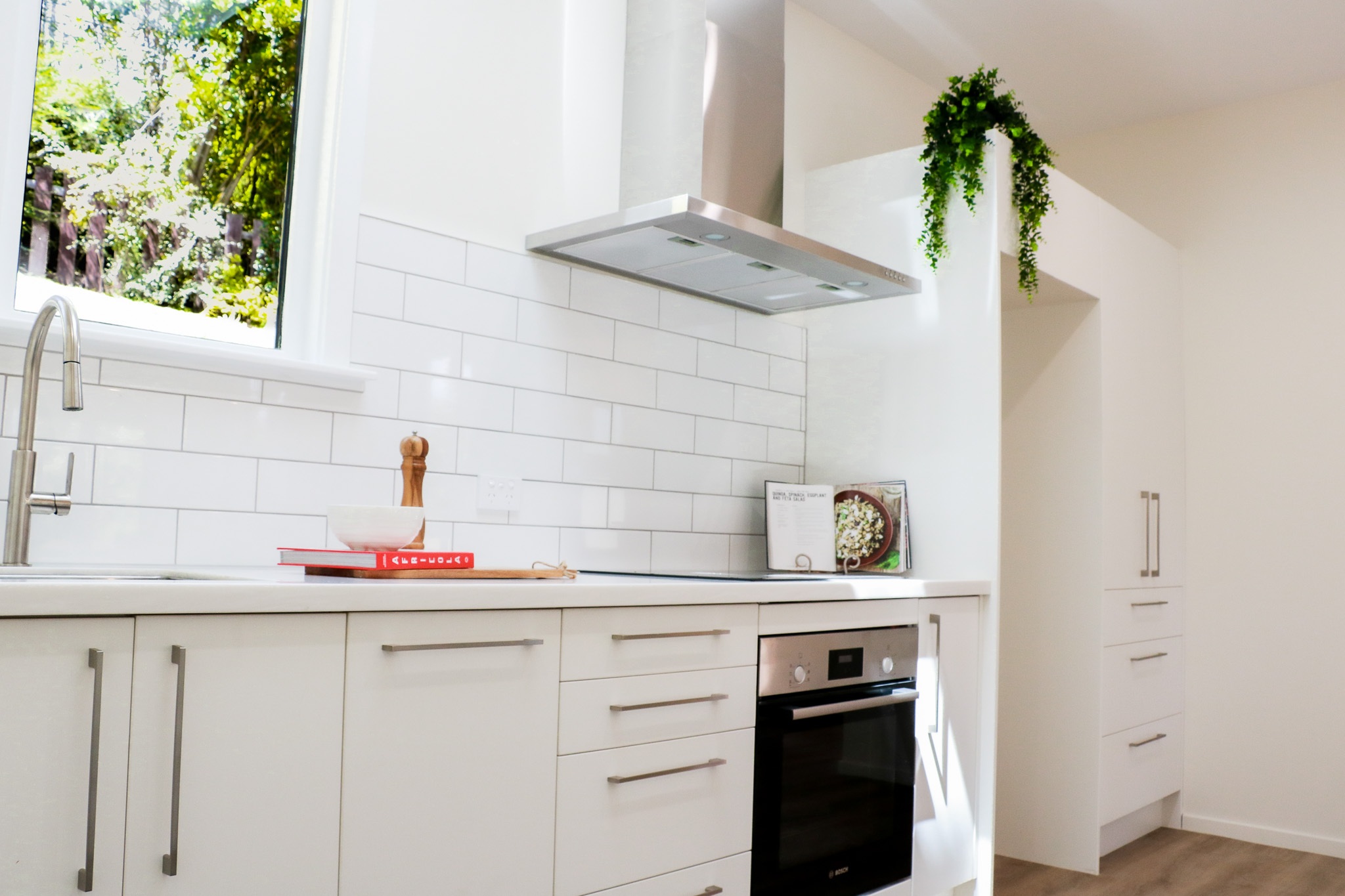 Newly renovated kitchen with white subway tiles, new appliances and styled.