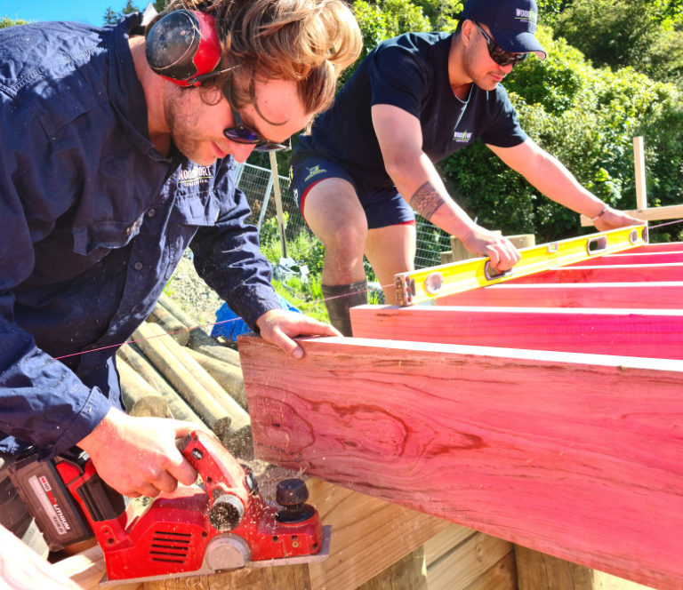 Two builders working on a building site for a new home